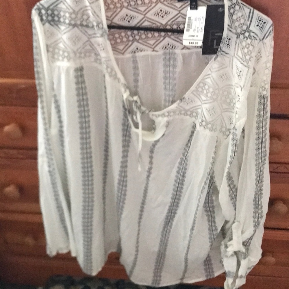 Long sleeve white with black design with tags